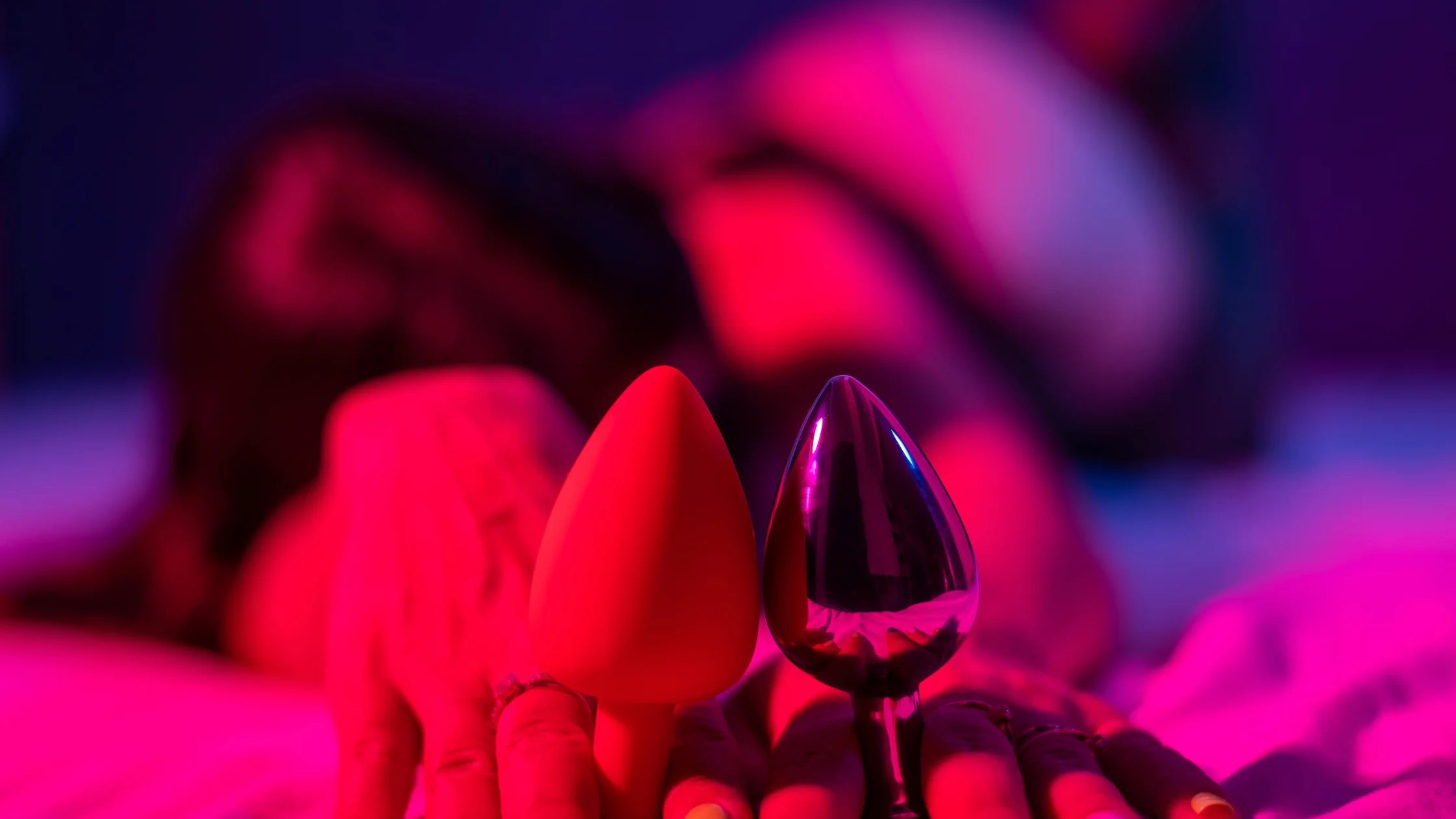 Two anal plugs held by women front view sex toy numen wellness