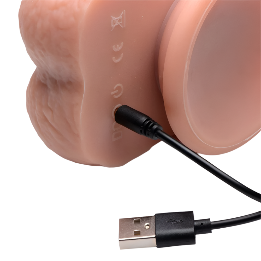 Thrusting Vibrator in flesh tone front view with smooth silicone finish with USB Charger